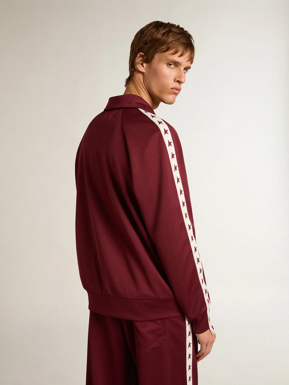 Men’s burgundy zipped sweatshirt with white strip and contrasting stars