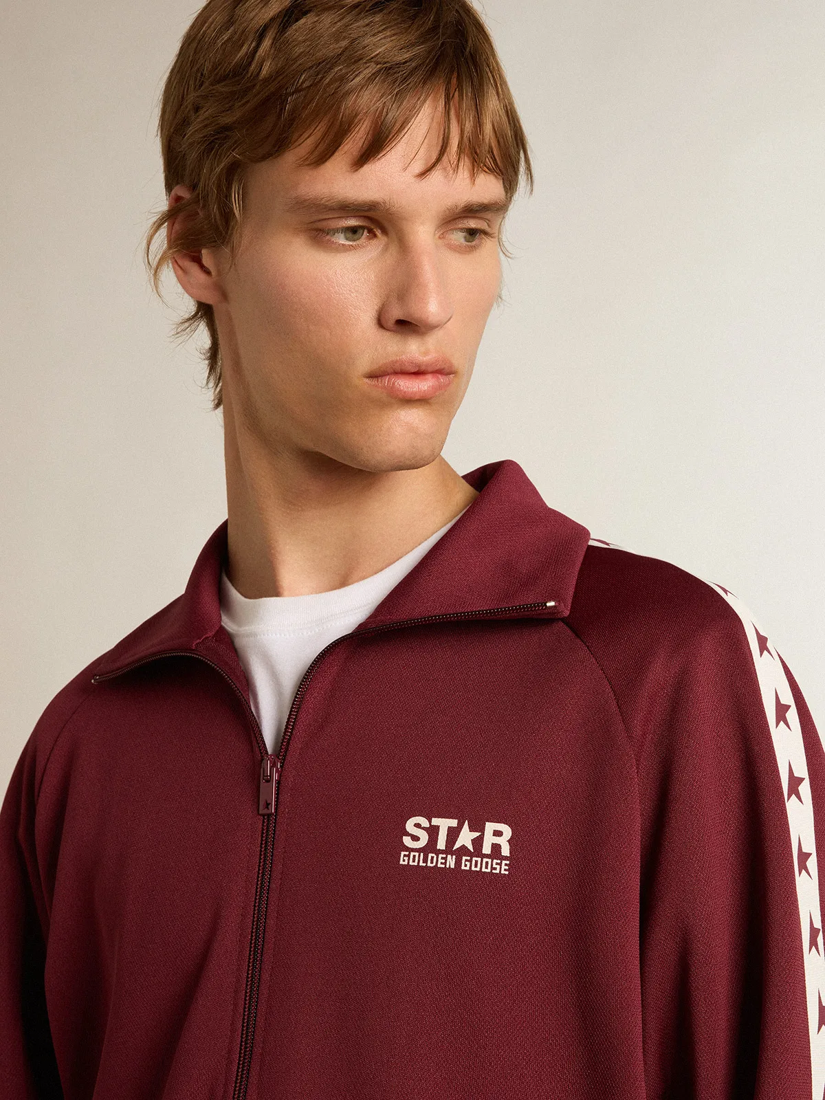 Men’s burgundy zipped sweatshirt with white strip and contrasting stars